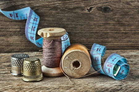 still life of spools of thread on a wooden background