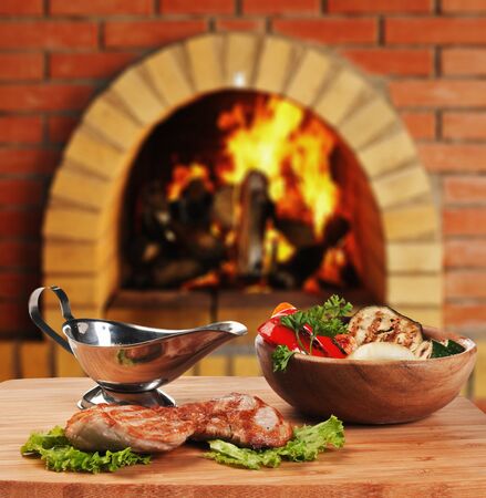 dishes of roast meat  in Russian cuisine  with an oven and a burningの写真素材