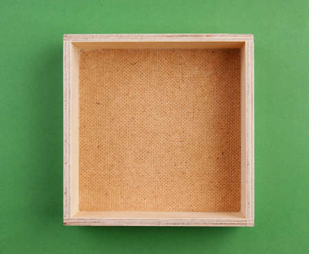 empty wooden box on a green background