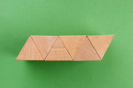 wooden geometric shapes on a green backgroundの写真素材