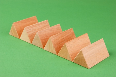 wooden geometric shapes on a green backgroundの写真素材