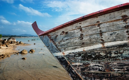 old fishing boat on the beach of the Indian Ocean phuket thailand