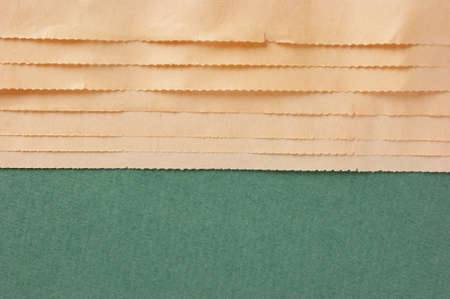 edge of the old newspaper on a green background