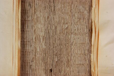 edge of the old newspaper on a wooden backgroundの写真素材