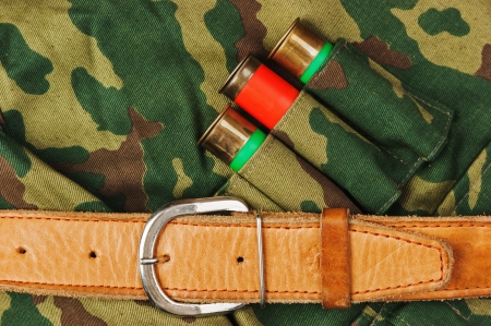 Old hunting cartridges and bandoleer on camouflage backgroundの写真素材