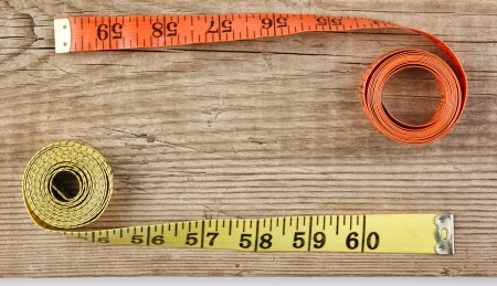 sartorial meter and scissors on the old wooden backgroundの写真素材