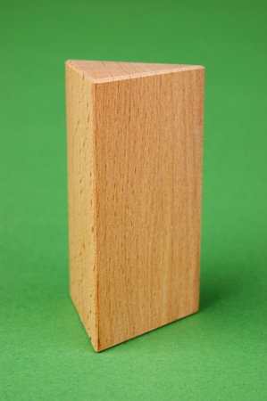 wooden geometric shapes on a green backgroundの写真素材