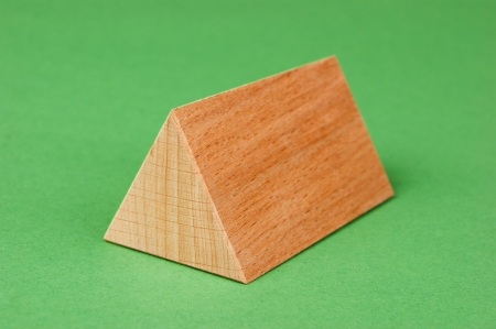 wooden geometric shapes on a green backgroundの写真素材