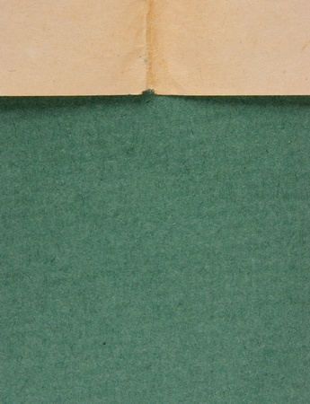edge of the old newspaper on a green backgroundの写真素材