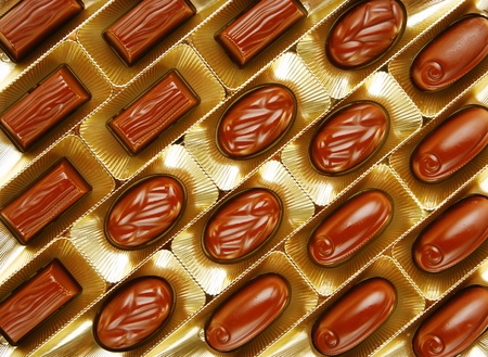 chocolate candies in a gold gift boxの写真素材