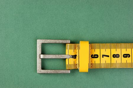 meter belt slimming on the green backgroundの写真素材