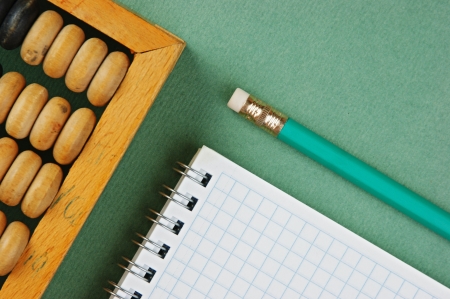 old abacus and notebook on the green backgroundの写真素材