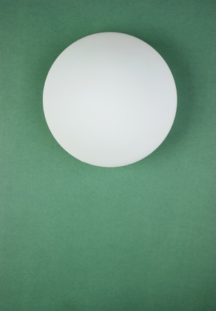 round white lamp on the green wallの写真素材