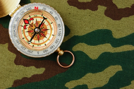 Compass on a camouflage backgroundの写真素材