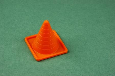 Plastic traffic cone on the green backgroundの写真素材