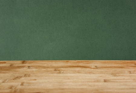 wooden deck table with green grunge backgroundの写真素材