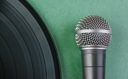 microphone and old vinyl record  on a green backgroundの写真素材
