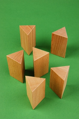 wooden geometric shapes on a green background