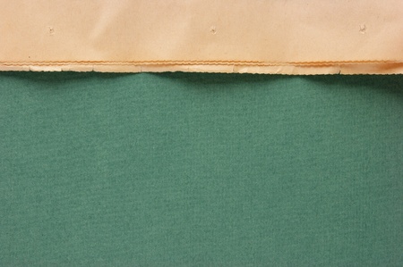 edge of the old newspaper on a green backgroundの写真素材