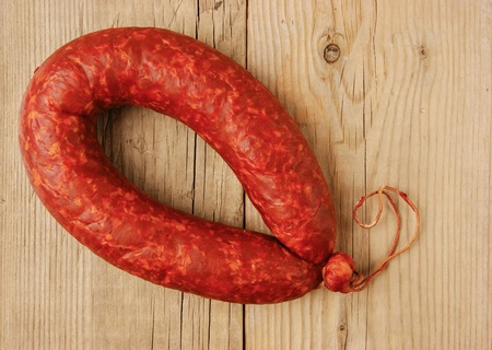 Krakow sausage isolated on the wooden tableの写真素材