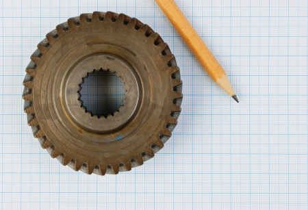 Gear and pencil on graph paperの写真素材