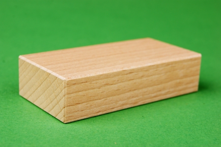 wooden geometric shapes on a green backgroundの写真素材