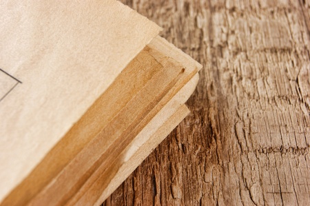 edge of the old newspaper on a wooden backgroundの写真素材