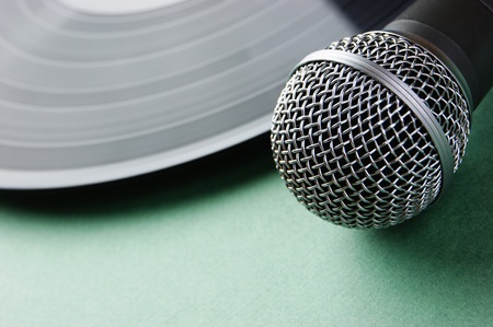 microphone and old vinyl record  on a green backgroundの写真素材