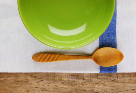 wooden spoon with a plate on the table cloth on an old wooden tableの写真素材