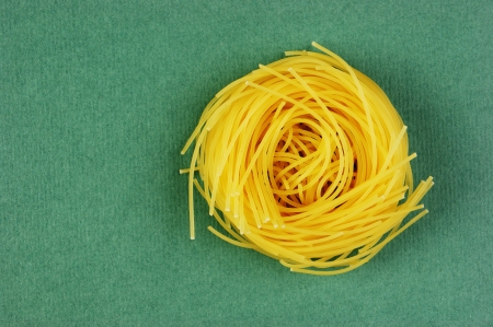 Tagliatelle pasta background on the green backgroundの写真素材