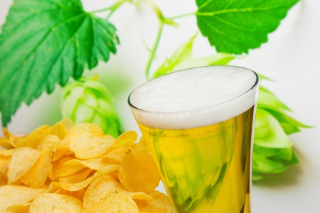 glass of beer and potato chips in a landscapeの写真素材