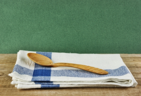 wooden spoon and dishcloth on old wooden tableの写真素材