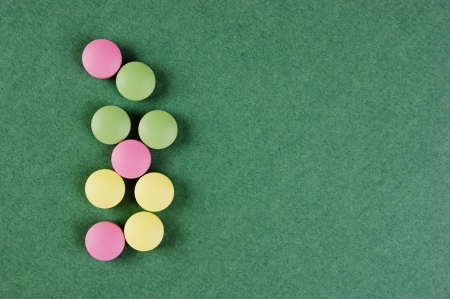 Pills and tablets on a green backgroundの写真素材