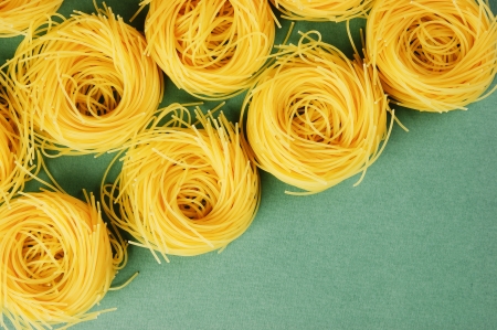 Tagliatelle pasta background on the green backgroundの写真素材