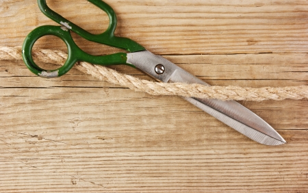 old tailor scissors and rope on the wooden backgroundの写真素材