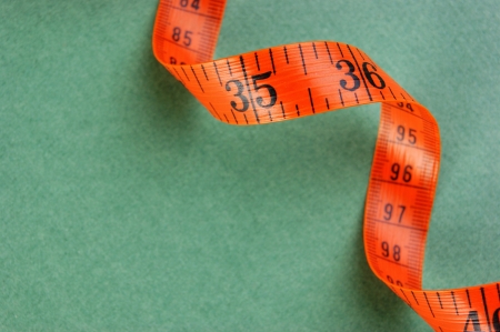 Orange sartorial meter on a green backgroundの写真素材