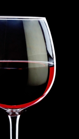 wine glass with red wine isolated on black backgroundの写真素材