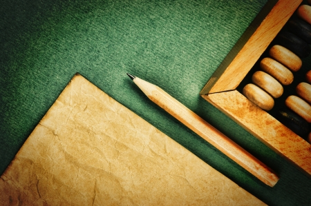 old abacus and notebook on the green backgroundの写真素材
