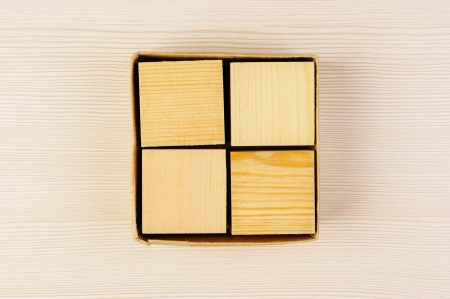 wooden geometric cube in a boxの写真素材