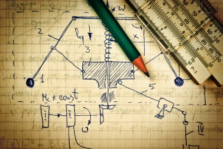 pencil and a slide rule on the old page with the calculations in mechanicsの写真素材
