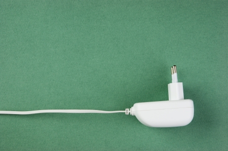 white electrical cable with plug on the green backgroundの写真素材