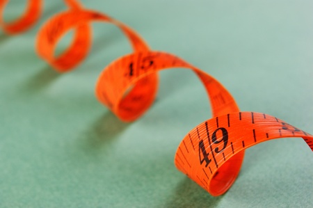 Orange sartorial meter on a green backgroundの写真素材