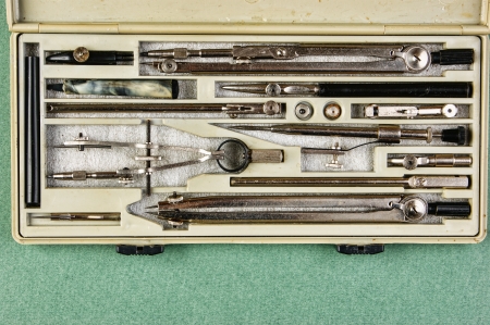 Old drawing tools in a box on a green backgroundの写真素材