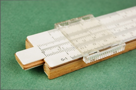 slide rule on a green backgroundの写真素材