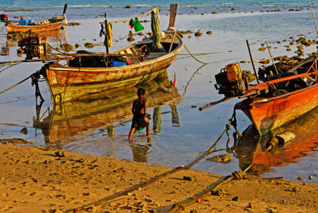national fishing boats on the shore of the Indian Ocean phuket thailandの写真素材