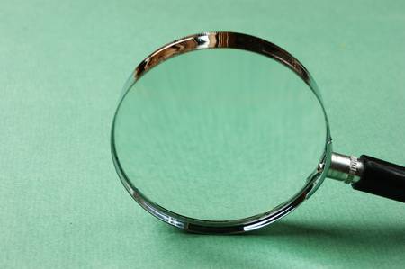 magnifying glass on green backgroundの写真素材