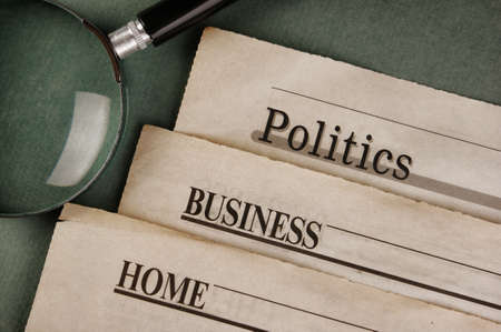 old newspaper and magnifying glass on a green backgroundの写真素材