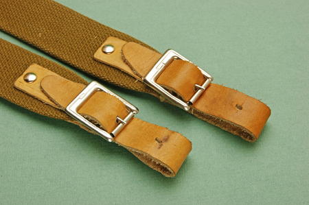 leather strap with a buckle on a green backgroundの写真素材