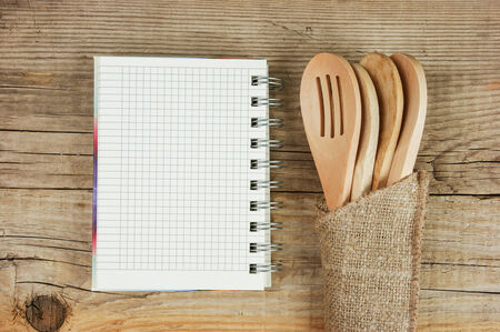 wooden spoon and notebook on old wooden tableの写真素材