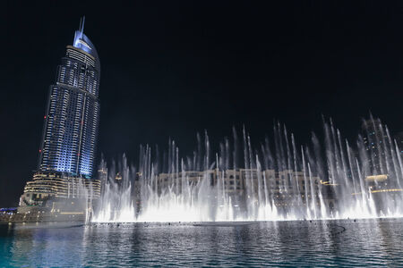 DUBAI, UAE - OCTOBER 31, 2013: Fountain in the lake near Dubai Mall. Lake - 6600 lights and 25 projectors, it shoots water 150 m into the air. United Arab Emirateのeditorial素材